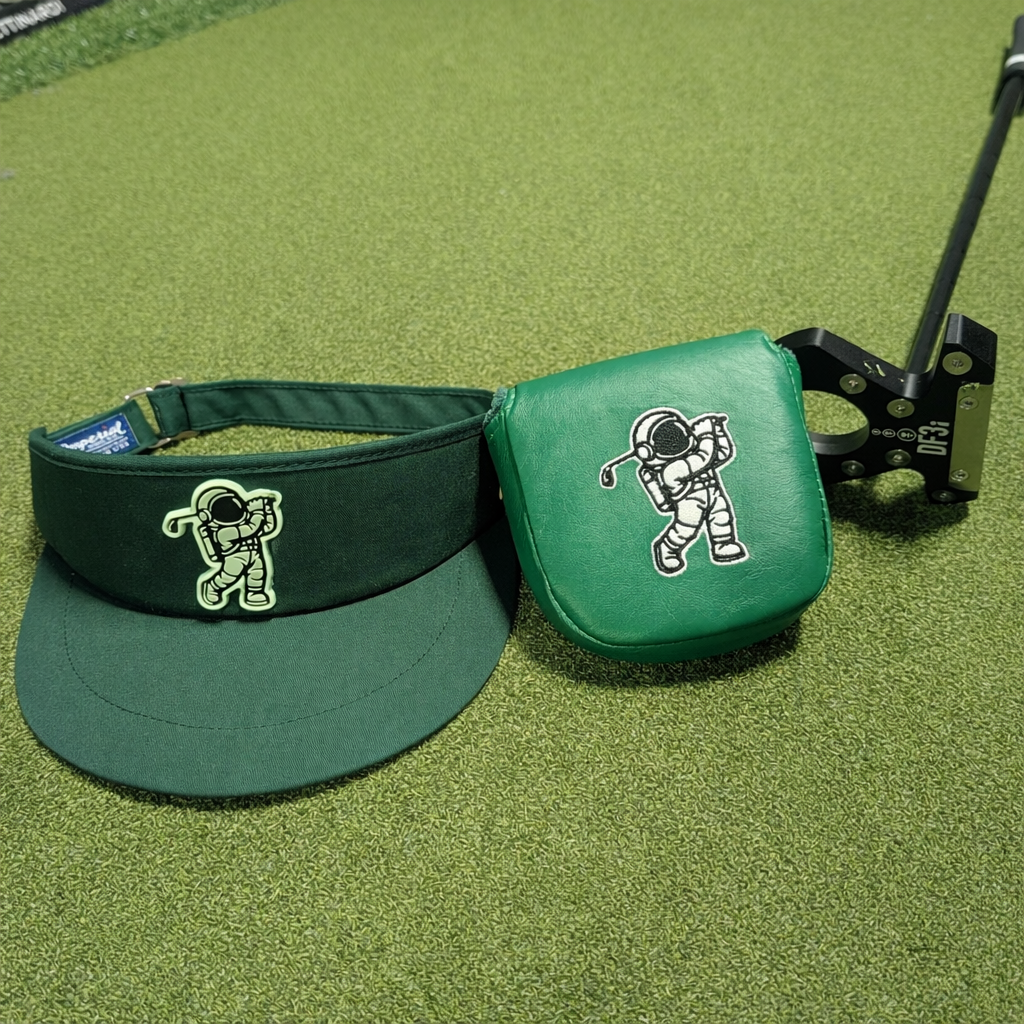Green visor and lab golf DF3 headcover with an astronaut design on a green surface