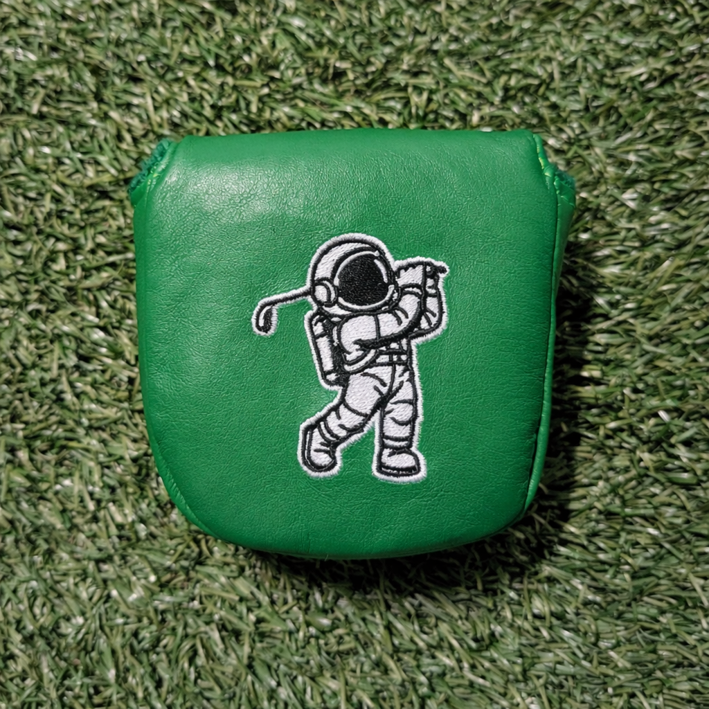 Green leather golf club head cover with an astronaut design on a grass background