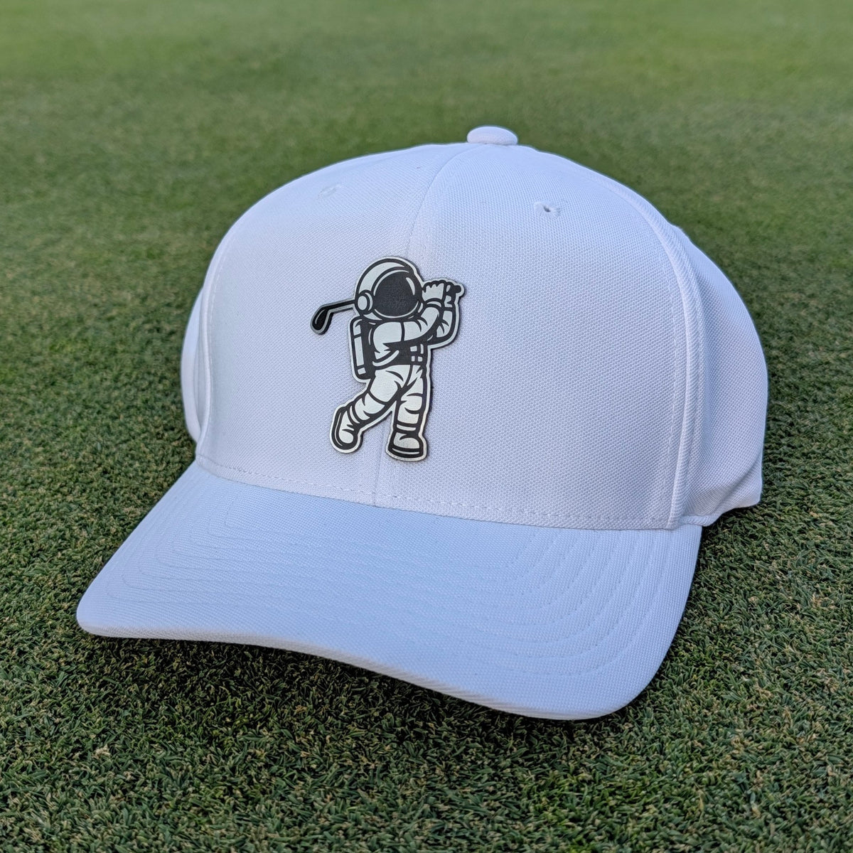 metal steel astronaut swinging a golf club on a white golf hat
