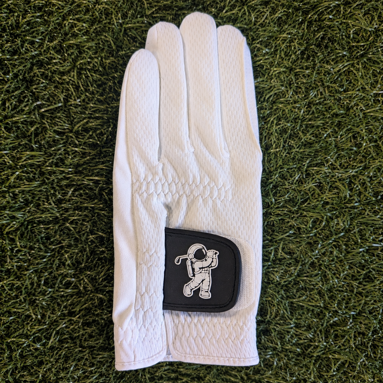 white golf glove on green grass background